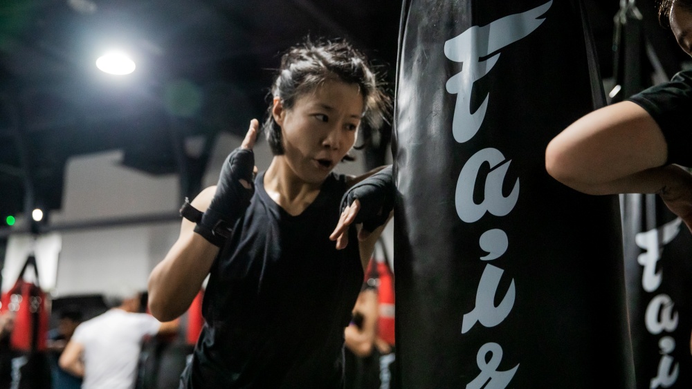 Student doing elbow work on heavy bag